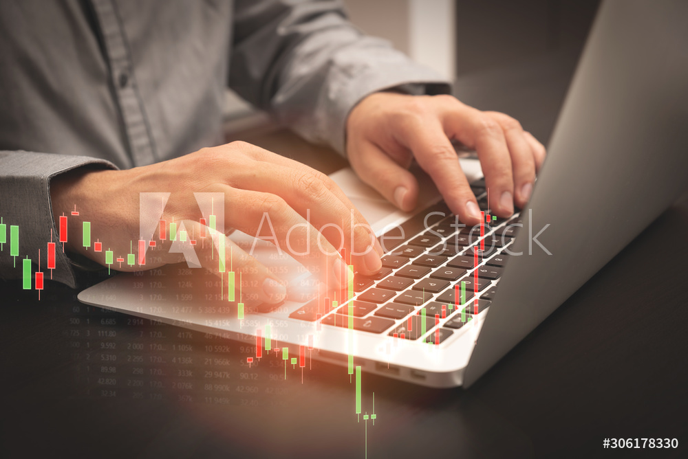 Investor, broker working with laptop